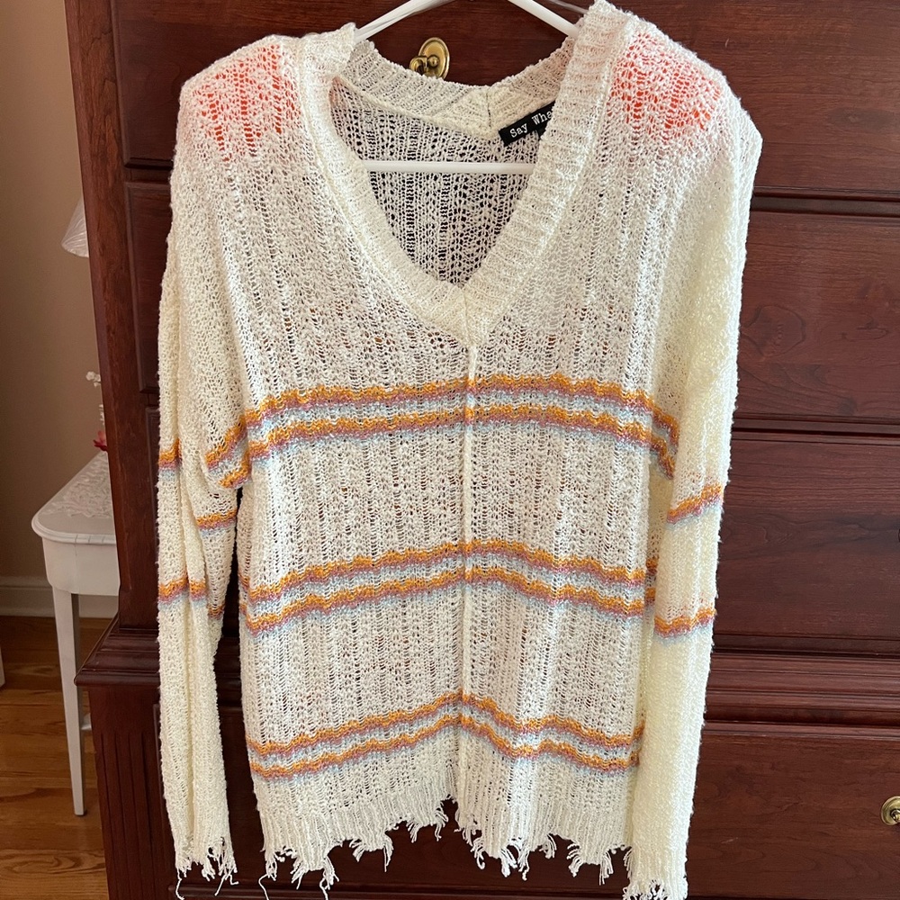Trendy stylish sweater. Finished hem and sleeves with ripped edging.